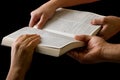 Hands Pulling a Bible