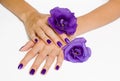 Hands with purple manicure and flowers