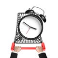 Hands pushing shopping cart with alarm clock