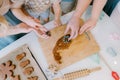 Hands put gingerbread cookies on a baking sheet Royalty Free Stock Photo