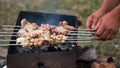 Hands put kebabs on a barbecue Royalty Free Stock Photo