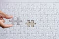 Hand putting piece to white jigsaw puzzle,Success solution template,Concept partnership business successful teamwork Royalty Free Stock Photo