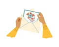 Hands putting postcard from mail envelope, flat vector illustration isolated. Royalty Free Stock Photo