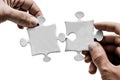 hands putting puzzle pieces together