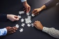 Hands, puzzle and business people with teamwork, planning and brainstorming for project or cooperation. Closeup, staff Royalty Free Stock Photo