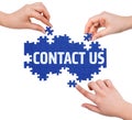 Hands with puzzle making CONTACT US word Royalty Free Stock Photo