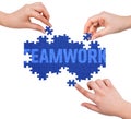 Hands with puzzle making TEAMWORK word Royalty Free Stock Photo