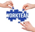 Hands with puzzle making WORKTEAM word