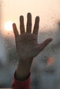 Hands on a raindrop window