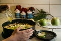 Hands and raw apple pie with hany on table with towel and knife