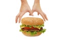 Hands reach for a hamburger