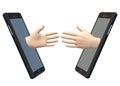 Hands reaching out towards one another from two facing smartphones white backdrop