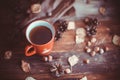 Hands in red knitted gloves holding a hot cup of coffee against yellow leaves background. Concept of autumn time, warmth and cozin Royalty Free Stock Photo