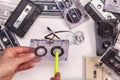 Hands reeling tape back into audio compact cassette Royalty Free Stock Photo