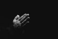 Hands of religious man praying on dark background, black and white effect Royalty Free Stock Photo