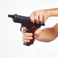 Hands reload pistol on white background