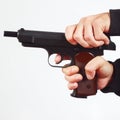 Hands reload semi-automatic gun on white background