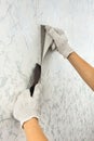 Hands removing old wallpaper with spatula Royalty Free Stock Photo