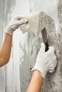 Hands removing old wallpaper with spatula during repair Royalty Free Stock Photo