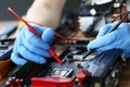 Hands are repairing electronic device, soldering