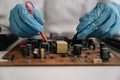 Hands repairing electronic devices. Electronic technician