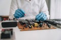 Hands repairing electronic devices. Electronic technician