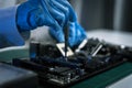 Hands repairing electronic devices. Electronic technician