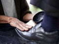 Hands, repairman and polishing with leather shoes for customer in handcraft, startup business and store. Entrepreneur