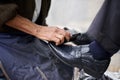 Hands, repairman and polishing shoes for customer in handcraft, startup business and store. Entrepreneur, shoemaker and