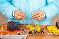 Hands repairman servicing electronic devices in service workshop