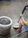 Hands of repairman using Water sprayer clean washing machine