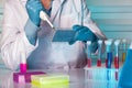 Hands of a researcher pipetting samples in micro plate Royalty Free Stock Photo