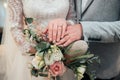 Hands with rings of the bride and groom are lying on the bouquet close-up Royalty Free Stock Photo