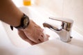 Hands rinsing in the sink after washing with soap