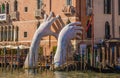 Hands rise from the water in Venice to highlight climate change