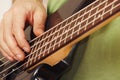 Hands of a rock guitarist playing the electric bass guitar Royalty Free Stock Photo