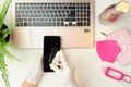 Hands in rubber gloves disinfecting smartphone with sanitizer