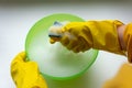 Hands in rubber protective gloves, a cleaning sponge with soap foam and a bowl. Window cleaning, home cleaning Royalty Free Stock Photo