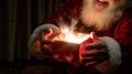 Hands of Santa Claus Holding Illuminated Christmas Gift Royalty Free Stock Photo