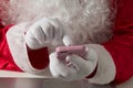 Hands of Santa Claus Using cell phone for communication and leis Royalty Free Stock Photo