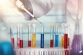 Hands of a scientist pipetting in tubes test