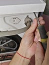 Hands screwdriver unscrew the rear upper part of the washing machine