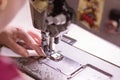 Hands of seamstress, fabric and sewing machine, close-up Royalty Free Stock Photo
