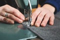 Hands of seamstress sewing with a professional machine