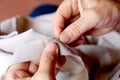 Hands of seamstress at work on the wooden chair with her cloth , hand made soft toys sewing with felt and needle.. Royalty Free Stock Photo