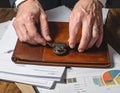 Hands Securing Lock on Leather Portfolio with Documents and Charts Royalty Free Stock Photo