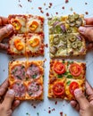 Hands selecting roman style pizza slices from a small rectangular pie on a bright white background Royalty Free Stock Photo