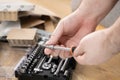 Hands selecting a versatile screwdriver from a comprehensive toolkit, preparing for furniture assembly, symbolizing practical DIY Royalty Free Stock Photo
