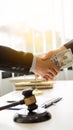 Lawyers and businessmen send money under corruption. Close-up of two businessmen shaking hands and taking bribes in the office