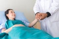 Hands senior man doctor reassuring her female patient in hospital room,Doctor giving a consultation and encouragement to patient,H Royalty Free Stock Photo